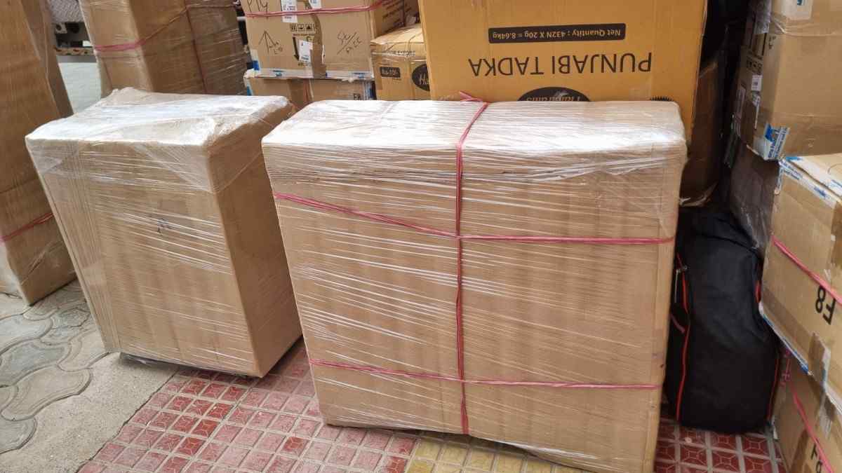 HK packers & Movers Packing Houehold items into cartons